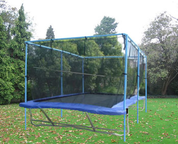 A Backyard Pro® trampoline sits above ground on a green lawn with evergreen trees and bushes in the background. It has blue wide pads with a black standard outdoor bed. Around the periphery of the trampoline is an attached safety enclosure net which is an optional accessory that we offer.